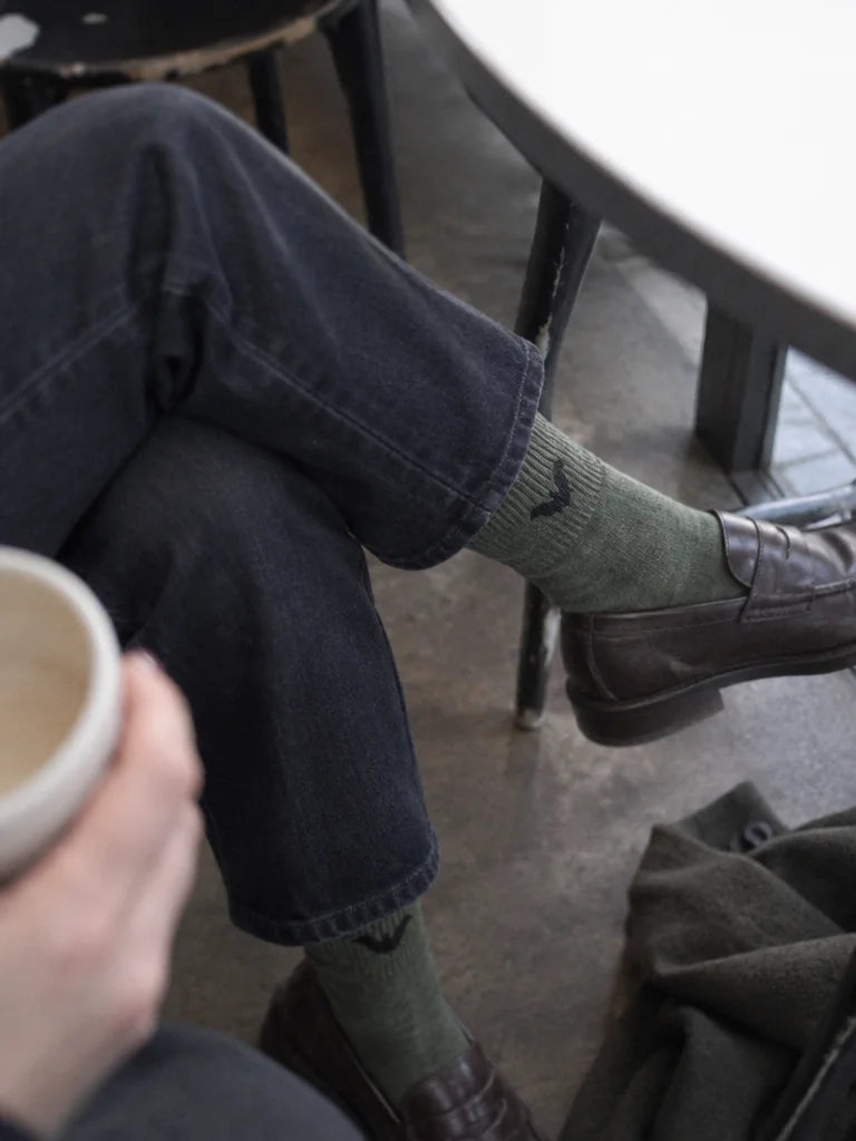 A customer's own photo, taken by her friend from close beside a small café table: the khaki mid-calf