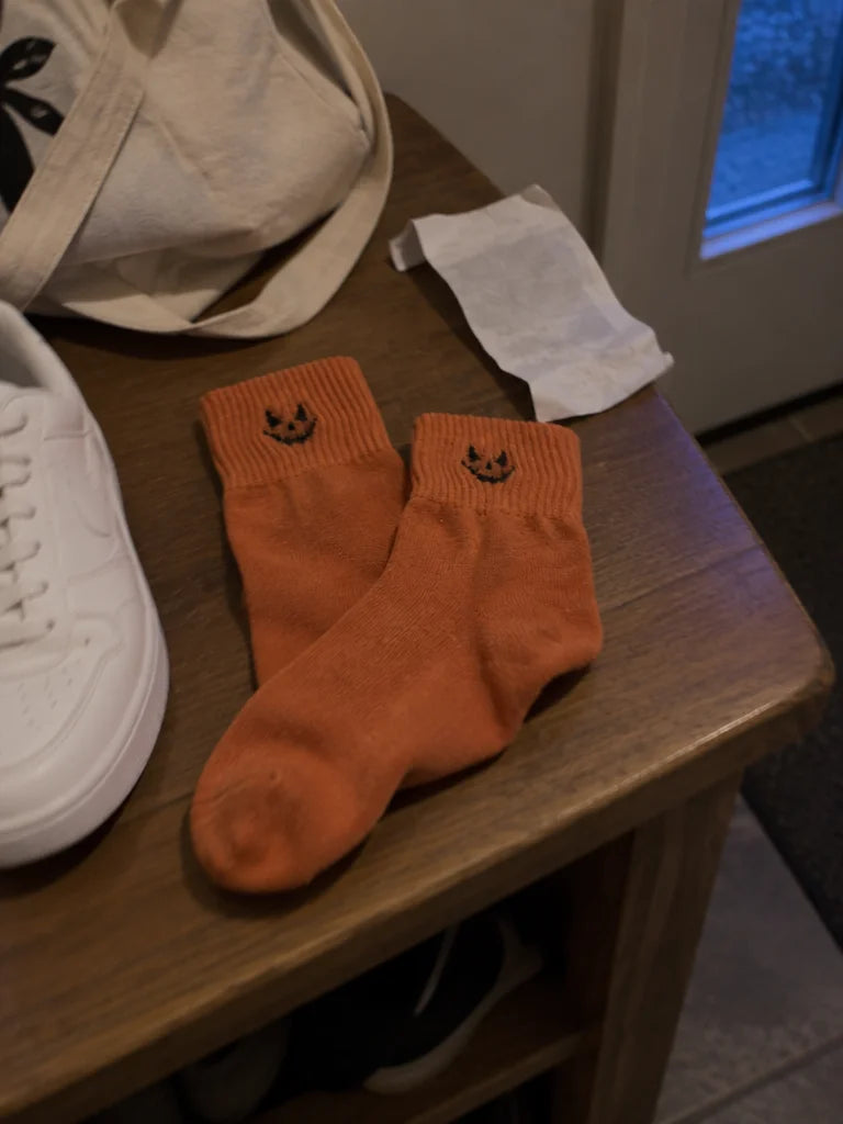 A customer's own photo of the things she had just taken off by her front door: one pair of orange mi