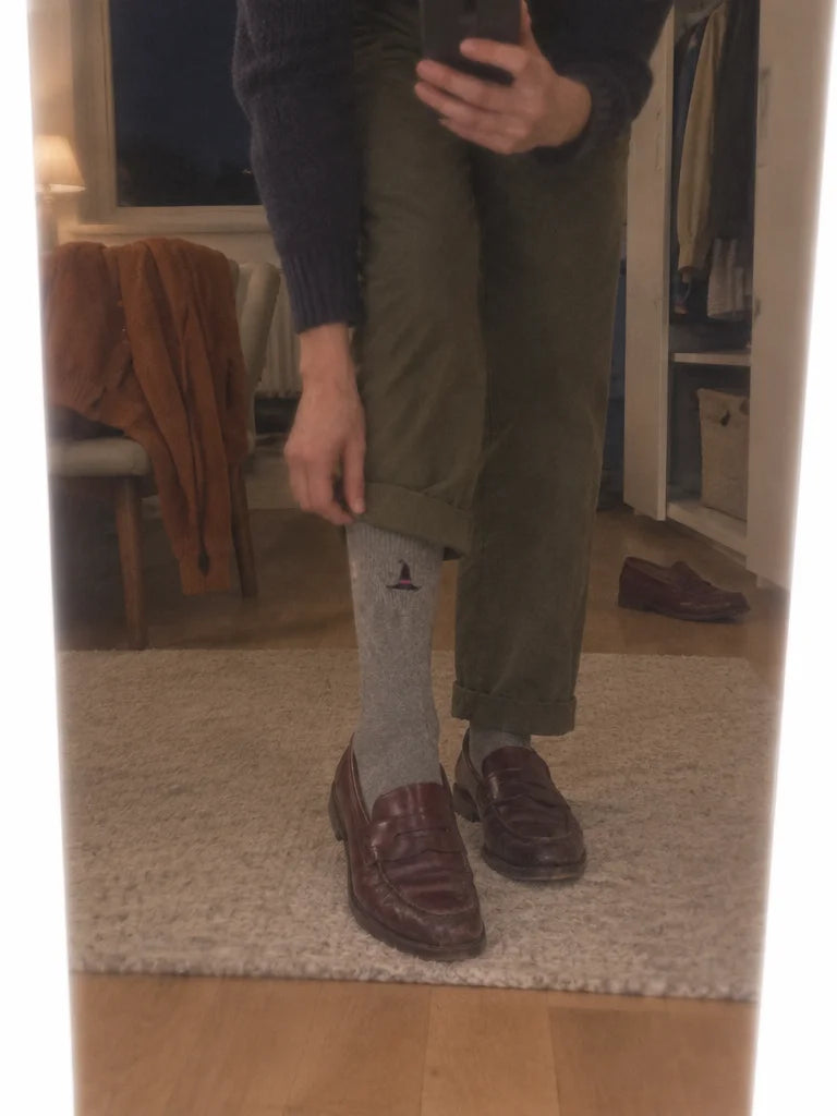 A customer's own mirror photo in a bedroom, reflection cropped from waist to floor: grey mid-calf so